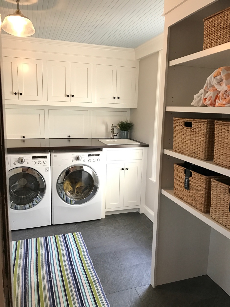 Mudroom Laundry Room Combination Sunken laundry room and mudroom combo feature gray cabinets with brass pull and a vintage wall mount sink faucet beside a subway tiled dog tub. branchville1923 com